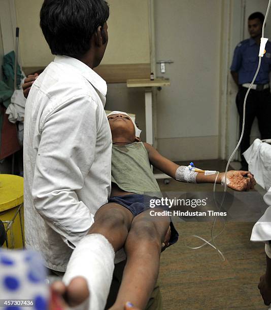 Injured students admitted at district hospital after a wall collapsed, at Barola village, on October 16, 2014 in Noida, India. At least one student...