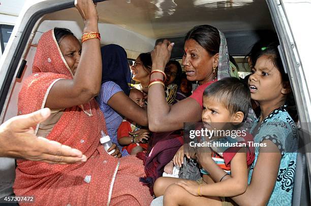 Relatives of the deceased Sanjay Kumar grieving at district hospital after a wall collapsed, at Barola village, on October 16, 2014 in Noida, India....