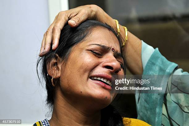 Mother of the deceased Sanjay Kumar grieving at district hospital after a wall collapsed, at Barola village, on October 16, 2014 in Noida, India. At...