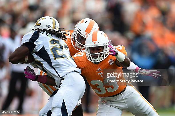 LaDarrell McNeil of the Tennessee Volunteers tackles Richardre Bagley of the Chattanooga Mocs during a game at Neyland Stadium on October 11, 2014 in...