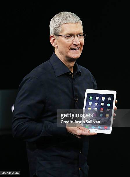 Apple CEO Tim Cook holds the new iPad Air 2 during a special event on October 16, 2014 in Cupertino, California. Apple unveiled the new iPad Air 2...