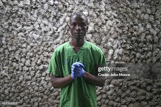 Ebola survivor James Harris stands for a portrait before a shift as a nurse's assistant at the Doctors Without Borders , Ebola treatment center on...