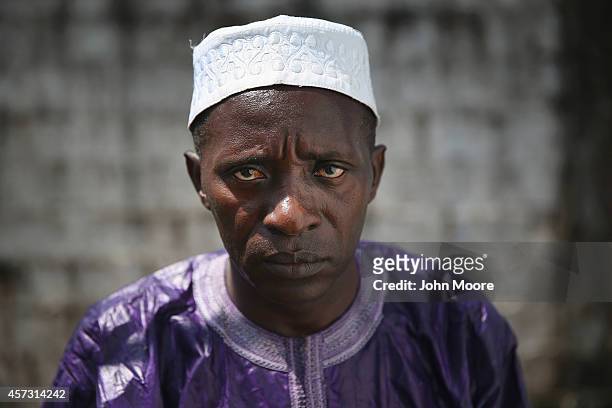 Ebola survivor Mohammed Bah stands at the Doctors Without Borders , Ebola treatment center after meeting with fellow survivors on October 16, 2014 in...