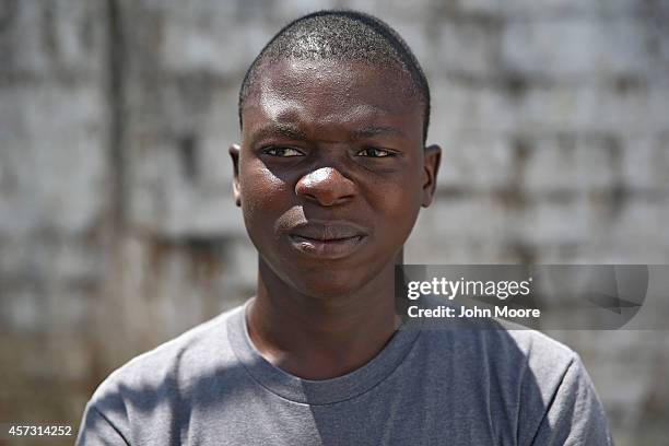 Ebola survivor Peters Roberts stands in the low-risk section of the Doctors Without Borders , Ebola treatment center after a survivors' meeting on...