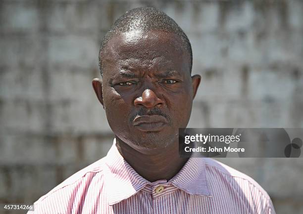 Ebola survivor Vavila Godoa stands in the low-risk section of the Doctors Without Borders , Ebola treatment center after survivors' meeting on...