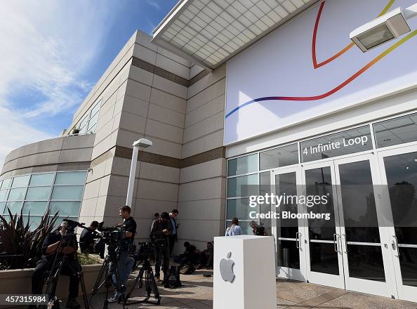 Members of the media wait outside the 4 Infinite Loop building during ...