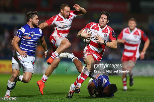 James Hook of Gloucester bursts past the challenge from Poutasi Luafutu of Brive during the European Rugby Challenge Cup Pool 5 match between...