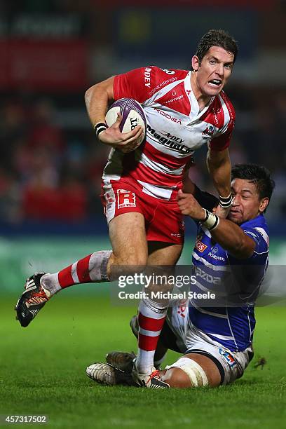 James Hook of Gloucester bursts past the challenge from Poutasi Luafutu of Brive during the European Rugby Challenge Cup Pool 5 match between...