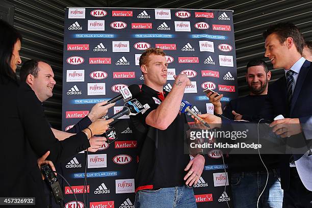 New recruit Adam Cooney swipes away a Bee during an Essendon Bombers AFL media session at True Value Solar Centre on October 17, 2014 in Melbourne,...