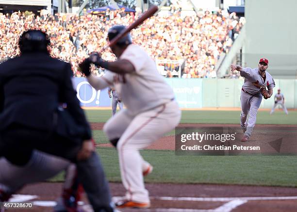 Adam Wainwright of the St. Louis Cardinals pitches in the first inning to Pablo Sandoval of the San Francisco Giants during Game Five of the National...