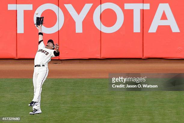 Travis Ishikawa of the San Francisco Giants is unable to catch a RBI double hit by Jon Jay of the St. Louis Cardinals in the third inning during Game...
