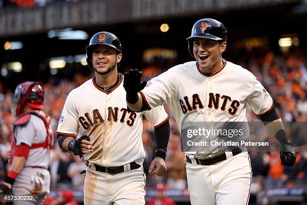 Joe Panik of the San Francisco Giants celebrates alongside Gregor Blanco after Panik hits a two-run home run in the third inning against the St....