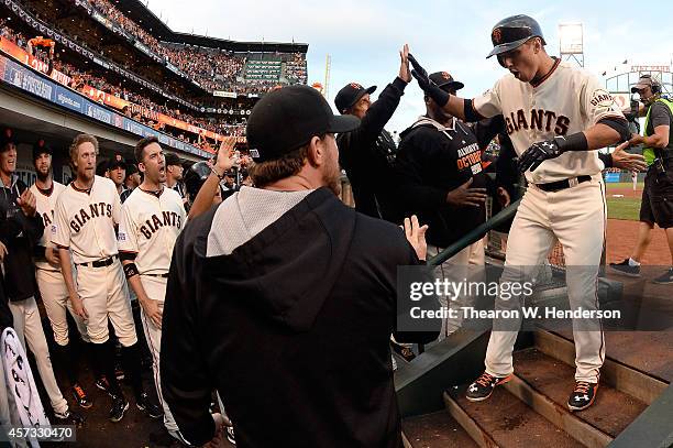 Joe Panik of the San Francisco Giants celebrates with teammates after hitting a two-run home run in the third inning against the St. Louis Cardinals...