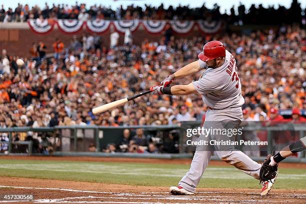 Matt Adams of the St. Louis Cardinals hits a solo home run in the fourth inning against the San Francisco Giants during Game Five of the National...