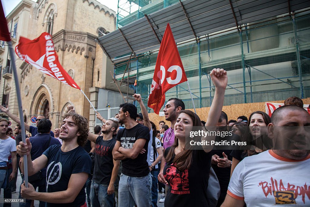 Thousands  of people bring banners and shout slogans in  the...