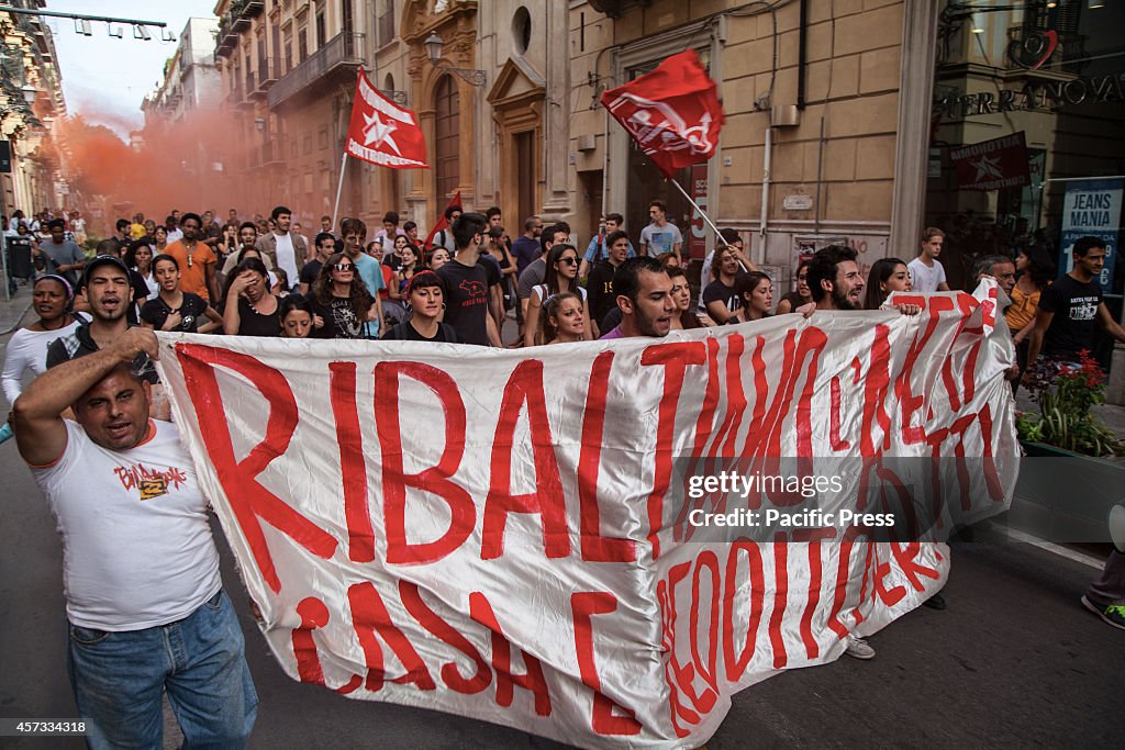 Thousands  of people bring banners and shout slogans in  the...