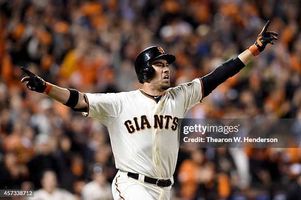 Travis Ishikawa of the San Francisco Giants celebrates after he hits a three-run walk-off home run to defeat the St. Louis Cardinals 6-3 during Game...