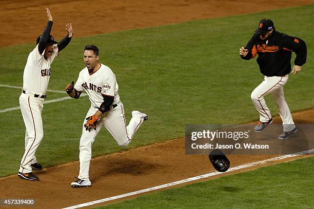 Travis Ishikawa of the San Francisco Giants celebrates after he hits a three-run walk-off home run to defeat the St. Louis Cardinals 6-3 during Game...