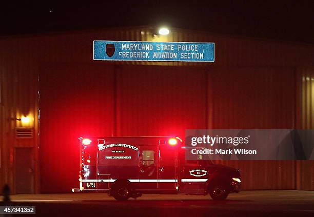 An ambulance carrying Texas Health Presbyterian Hospital nurse Nina Pham drives away from the Frederick Municipal Airport October 16, 2014 in...