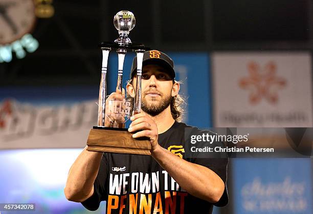 Madison Bumgarner of the San Francisco Giants holds up the NLCS MVP award after the Giants defeat the St. Louis Cardinals 6-3 during Game Five of the...