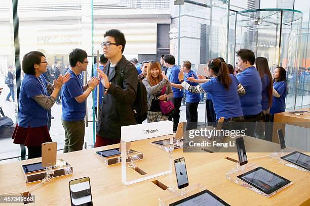 Apple store employees welcome the customers to buy iPhone 6 and iPhone 6 Plus at an Apple store on October 17, 2014 in Beijing, China. Apple Inc...