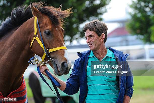 Trainer Phillip Atkins poses with In Cahoots at Flemington Racecourse on October 16, 2014 in Melbourne, Australia.