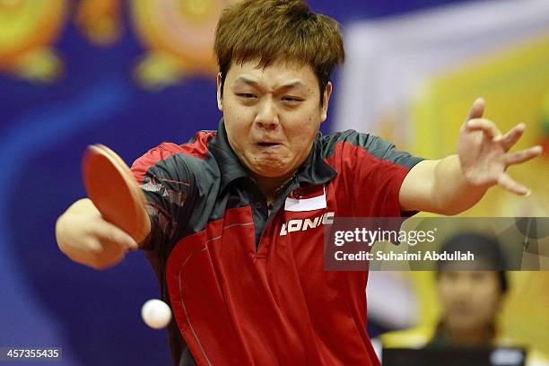 Li Hu of Singapore hits a return during the table tennis men's team event between Malaysia and Singapore at Wunna Theikdi Indoor Stadium C during the...