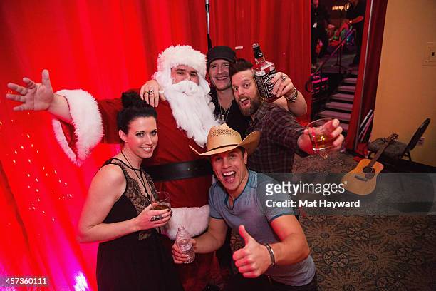 Shawna Thompson, Santa Claus, Dustin Lynch, Jerrod Niemann and Keifer Thompson pose backstage after performing for the Hometown Holiday show hosted...