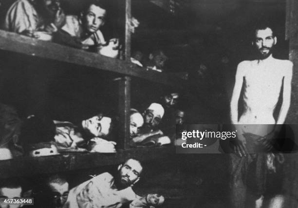 Jewish deportees in the Buchenwald concentration camp pose for a Soviet photographer when the Red Army re-staged the liberation of the Nazi's...