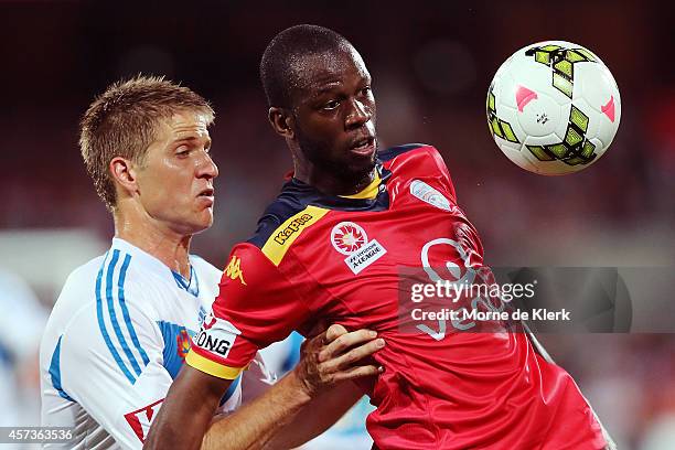 Bruce Djite of Adelaide competes with Adrian Leijer of Melbourne during the round two A-League match between Adelaide United and Melbourne Victory at...