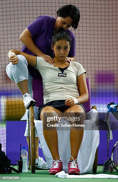 Zarina Diyas of Kazakhstan receives treatment against Monica Puig of Puerto Rico in the rising stars round robin match during previews for the WTA...