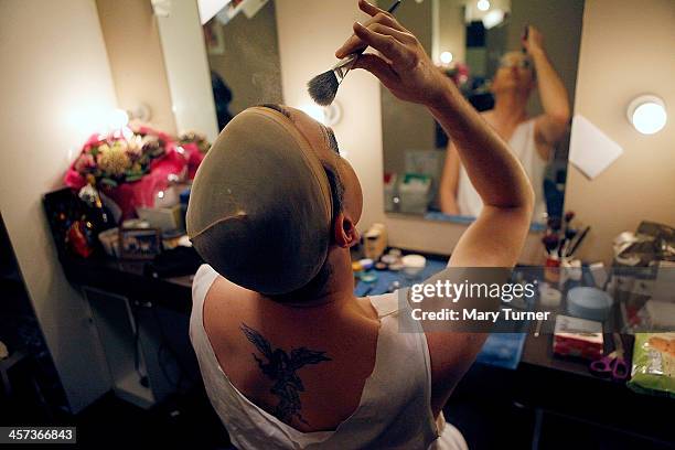 David Ball peppers his face with face-powder in his dressing room at the Churchill Theatre on December 12, 2013 in Bromley, England. David, who plays...