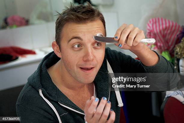 Pantomime Dame Steve Wickenden uses Pritt Stick pasted on with a knife to glue his eyebrows back, as he begins to transform himself into a pantomime...