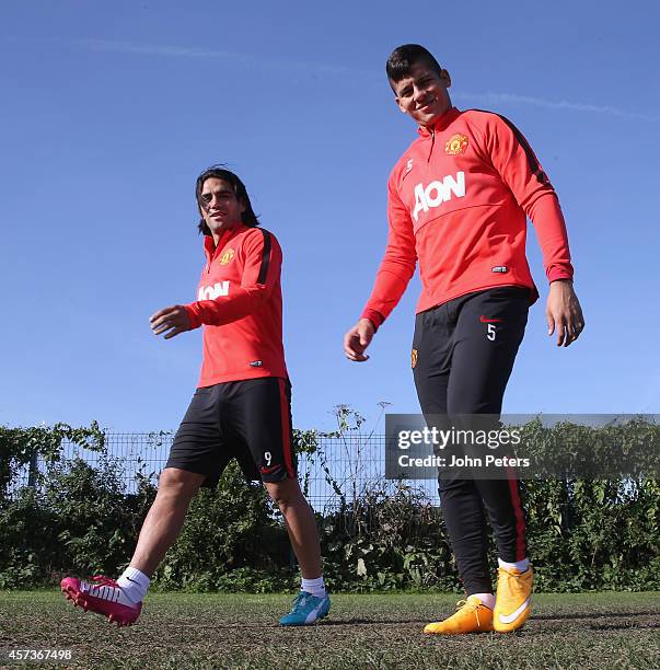 Radamel Falcao and Marcos Rojo of Manchester United in action during a first team training session at Aon Training Complex on October 17, 2014 in...