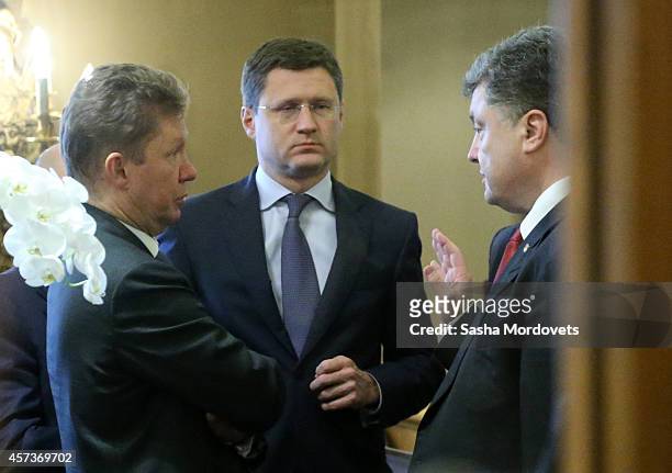 Ukrainian President Pyotr Poroshenko talks to Gazprom's CEO Alexei Miller and Russian Minister of Energy Alexander Novak during the ASEM Summit on...