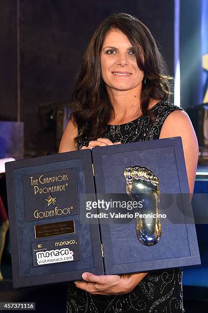 Mia Hamm receives the Golden Foot Award trophy during the Golden Foot Award 2014 ceremony at Sporting Club on October 13, 2014 in Monte-Carlo, Monaco.