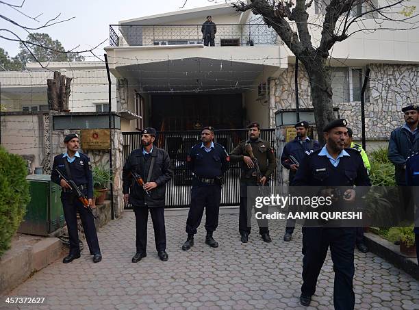 Pakistani policemen stand guard outside the High Commission of Bangladesh during a protest organised by civil society activists to protest against...