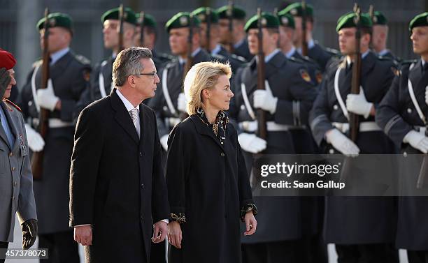 New German Defense Minister Ursula von der Leyen reviews soldiers of the Bundeswehr with outgoing Defense Minister Thomas de Maiziere shortly after...