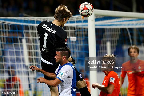 Andreas Luthe of Bochum extends a header against Anthony Losilla and Hanno Behrens of Darmstadt 98 to Mikael Forssell for a late goal during the...