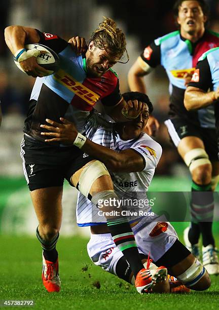 Luke Wallace of Harlequins is tackled by Piula Faasalele of Castres during the European Rugby Champions Cup Pool 2 match between Harlequins and...