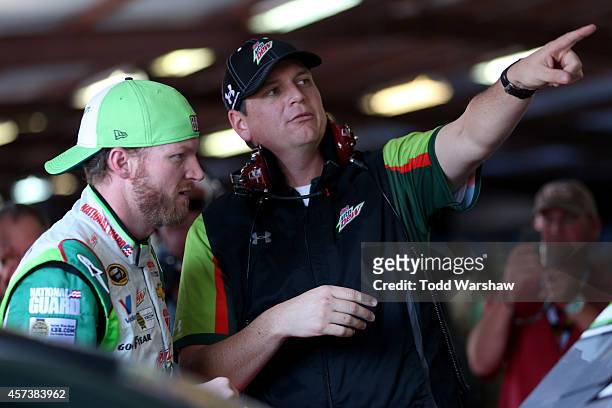 Dale Earnhardt Jr. , driver of the Diet Mountain Dew, talks to his crew chief, Steve Letarte, in the garage area during practice for the NASCAR...