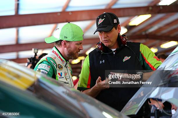 Dale Earnhardt Jr. , driver of the Diet Mountain Dew, talks to his crew chief, Steve Letarte, in the garage area during practice for the NASCAR...