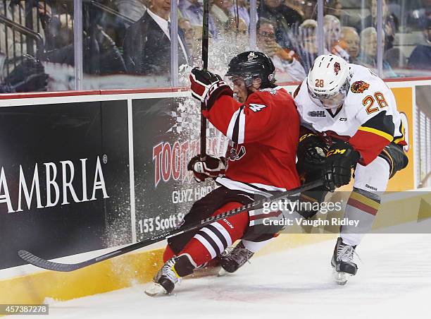 Vince Dunn of the Niagara Ice Dogs is chased down by David Tomasek of the Belleville Bulls in an OHL game at the Meridian Centre on October 16, 2014...