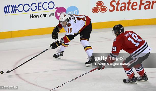 Cody Payne of the Niagara Ice Dogs chases Jake Marchment of the Belleville Bulls in an OHL game at the Meridian Centre on October 16, 2014 in St...