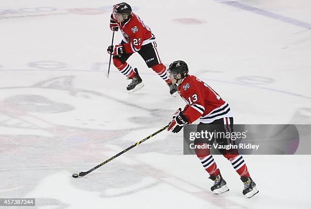 Graham Knott and Johnny Corneil of the Niagara Ice Dogs skate up the ice during an OHL game against the Belleville Bulls at the Meridian Centre on...