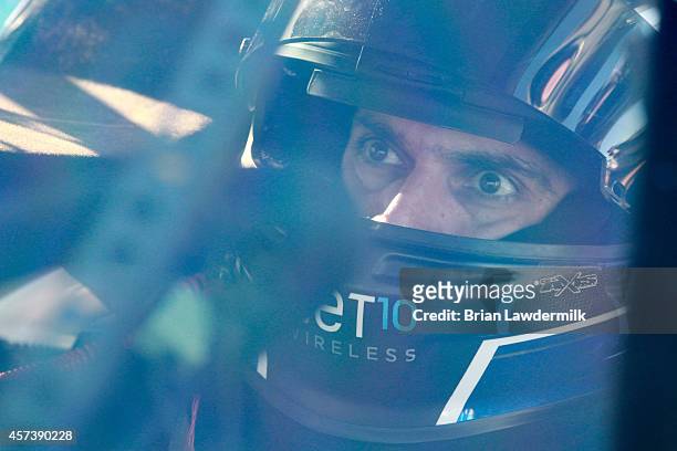 German Quiroga, driver of the NET10 Wireless Toyota, sits in his truck during qualifying for the NASCAR Camping World Truck Series Fred's 250 at...