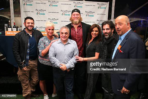 Adam Richman, Anne Burrell, Lee Brian Schrager, Nick Mangold, Rachael Ray, John Cusimano and Andrew Zimmern pose in front of the judges table at the...
