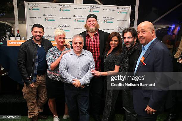 Adam Richman, Anne Burrell, Lee Brian Schrager, Nick Mangold, Rachael Ray, John Cusimano and Andrew Zimmern pose in front of the judges table at the...