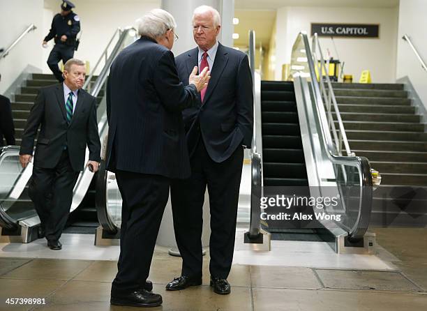 Sen. Saxby Chambliss listens to Sen. Carl Levin as Senate Majority Whip Sen. Richard Durbin passes by after a vote December 17, 2013 on Capitol Hill...