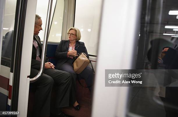 Senate Majority Leader Sen. Harry Reid talks to Sen. Claire McCaskill as they board the Senate subway after a vote December 17, 2013 on Capitol Hill...